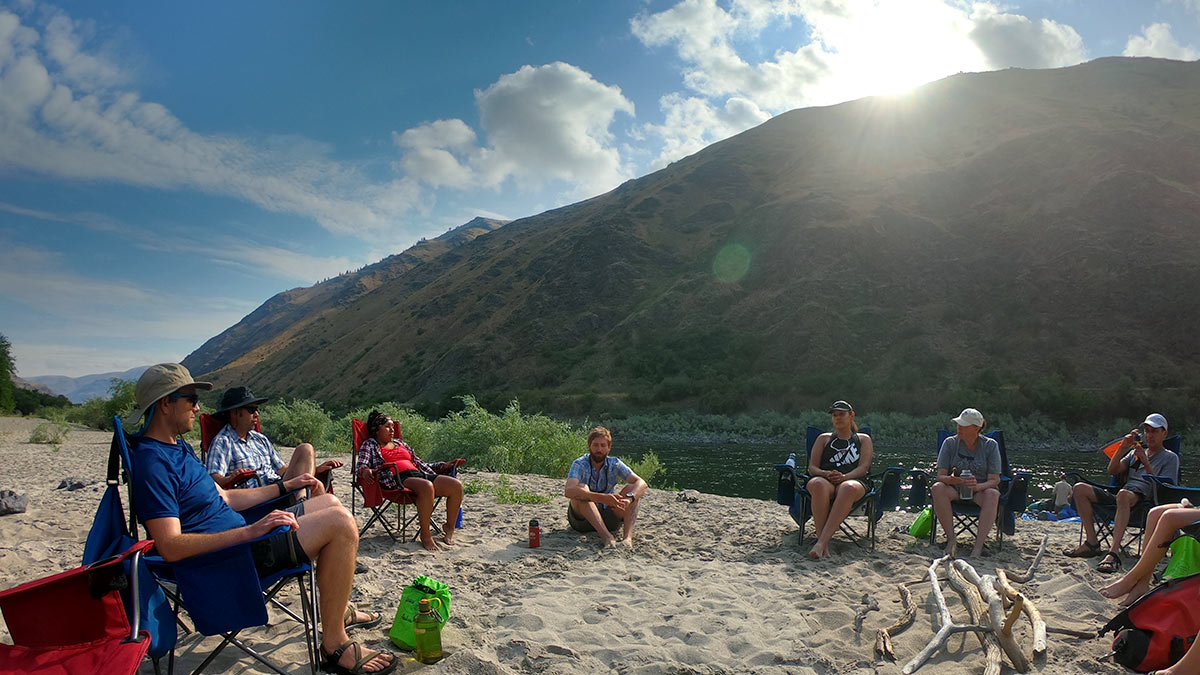 group relaxing on sandy shore