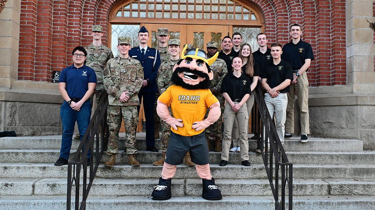 Joe Vandal poses with members of the military on the northern steps of the Administration Building.