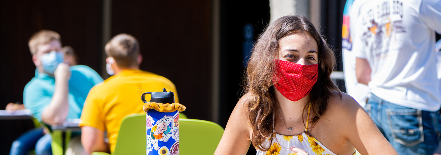 Student attending class with a mask on. 