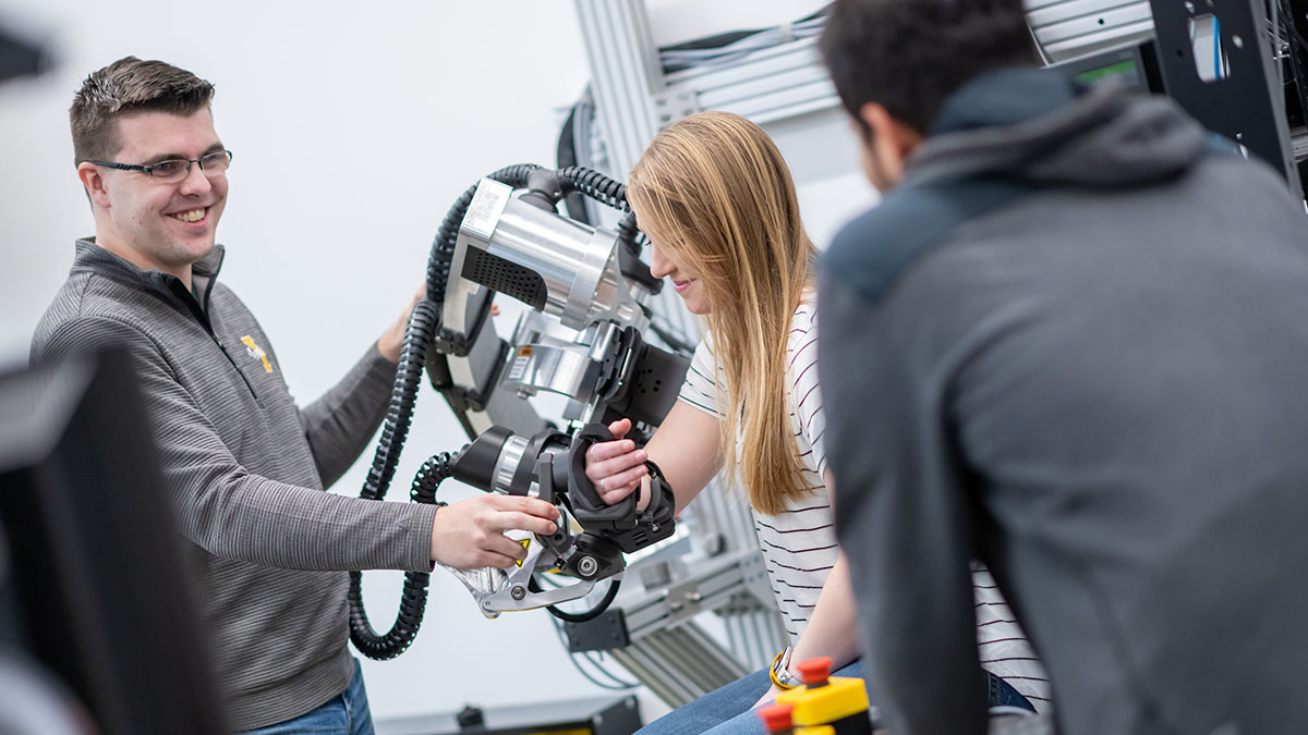 Students work with robotic devices used to develop better therapies for stroke patients.