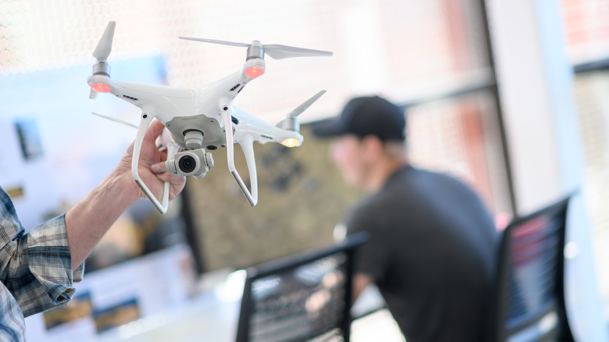 Dan Lauritzen holds a drone.