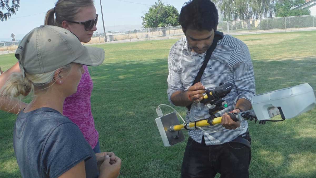 researcher with a device