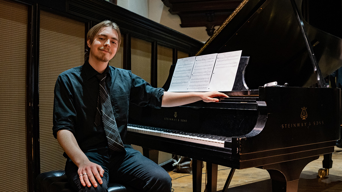 Spencer Cuppage sits at the piano